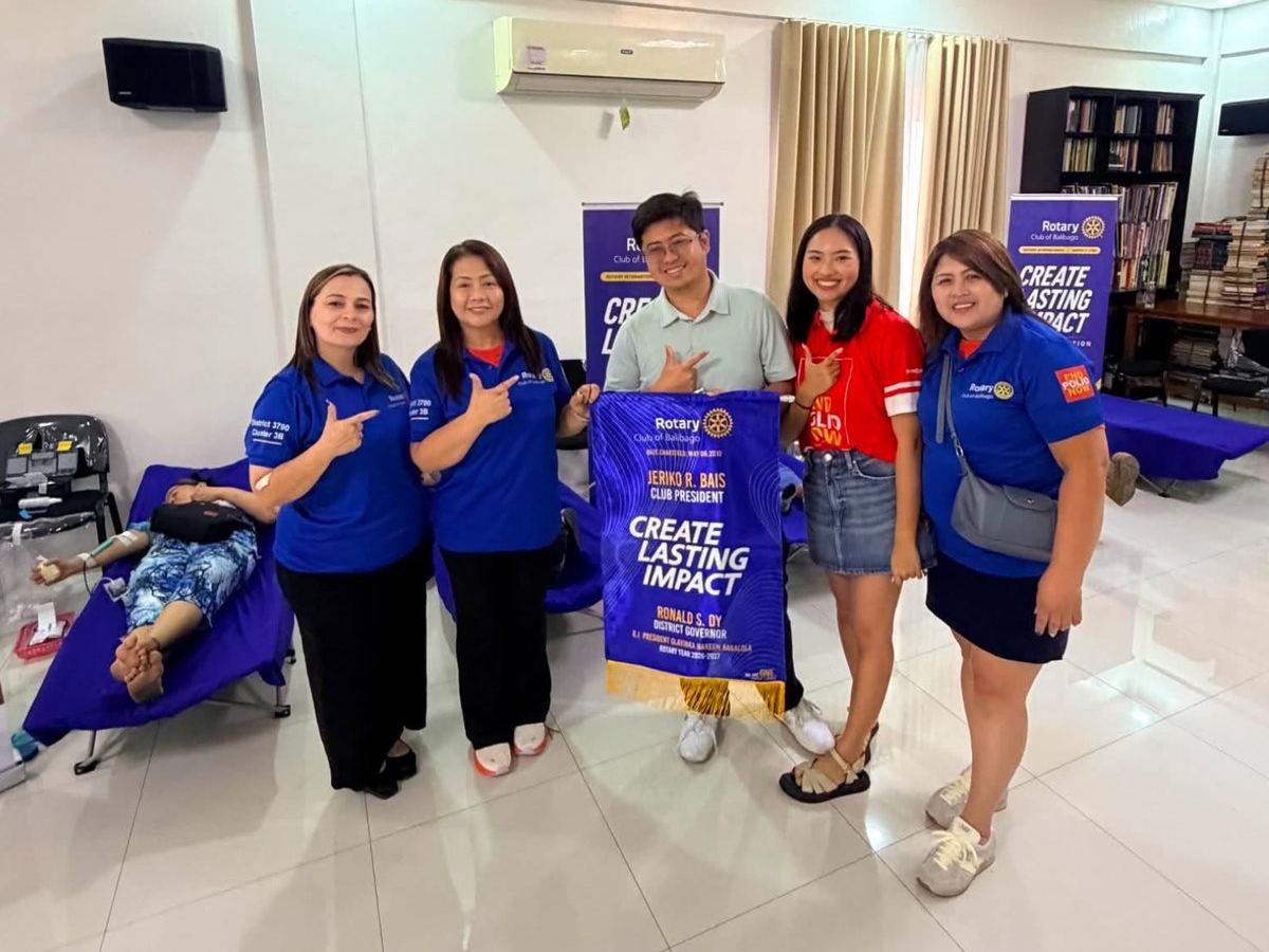 Members with the club banner at the blood donation drive