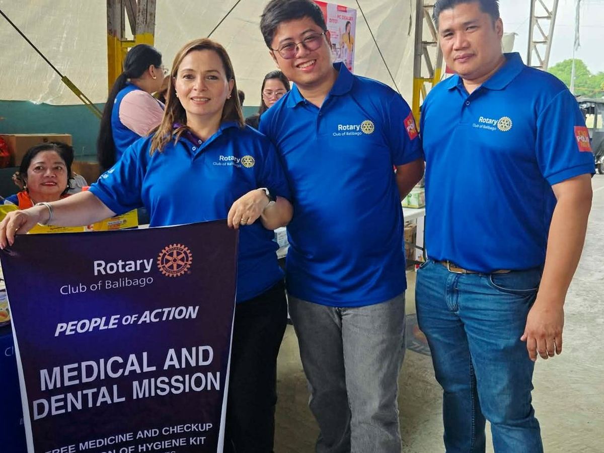 Members of the Rotary Club of Balibago holding the Medical and Dental Mission banner